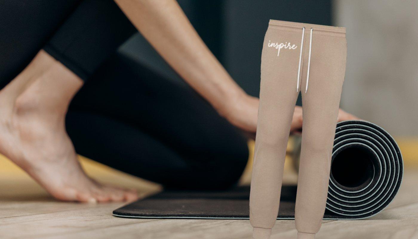 joggers with custom design in front of fitness background